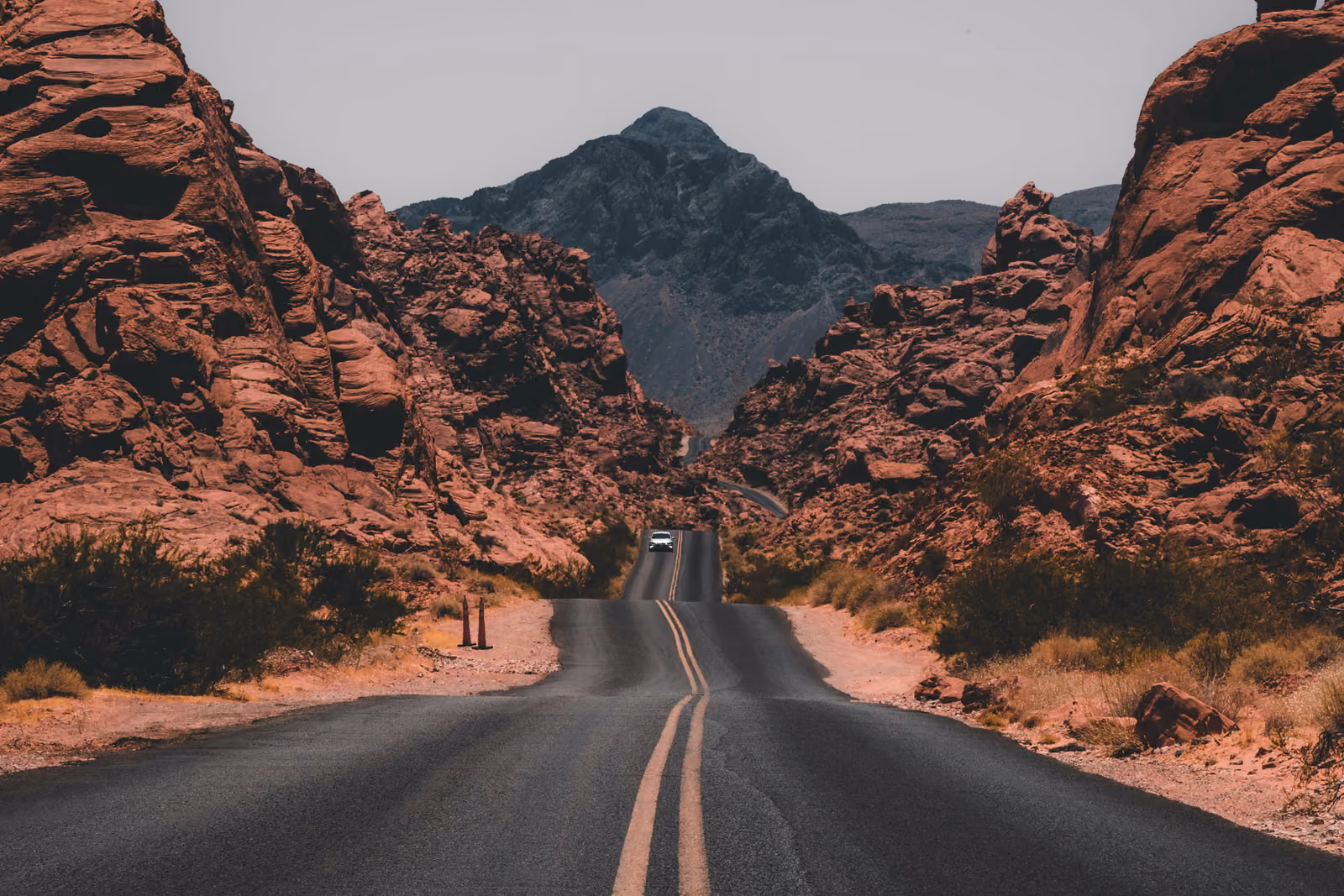 Misty sandstone peaks rising above a green valley